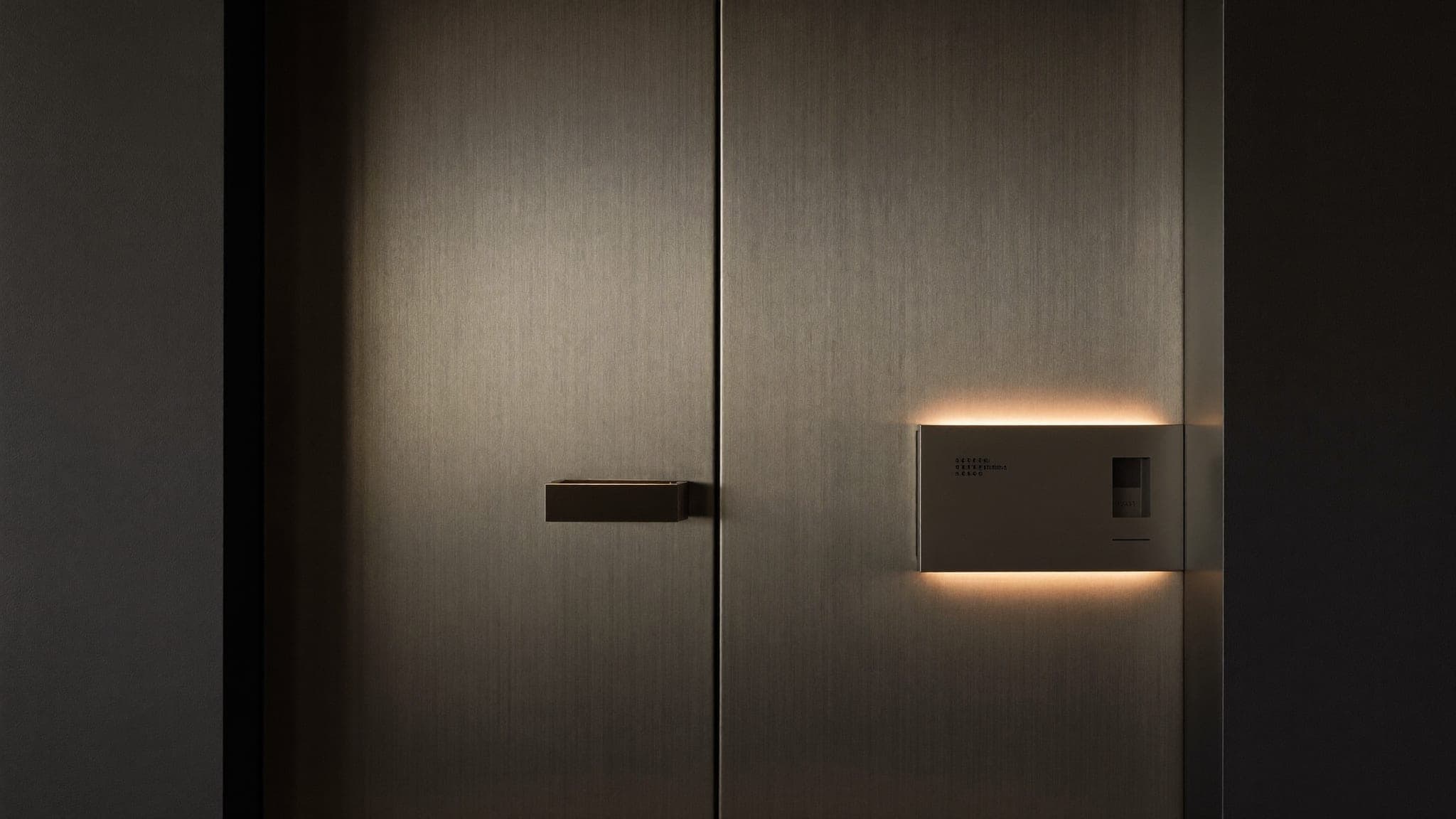 Brushed steel security door with minimal access control panel at Vault 620