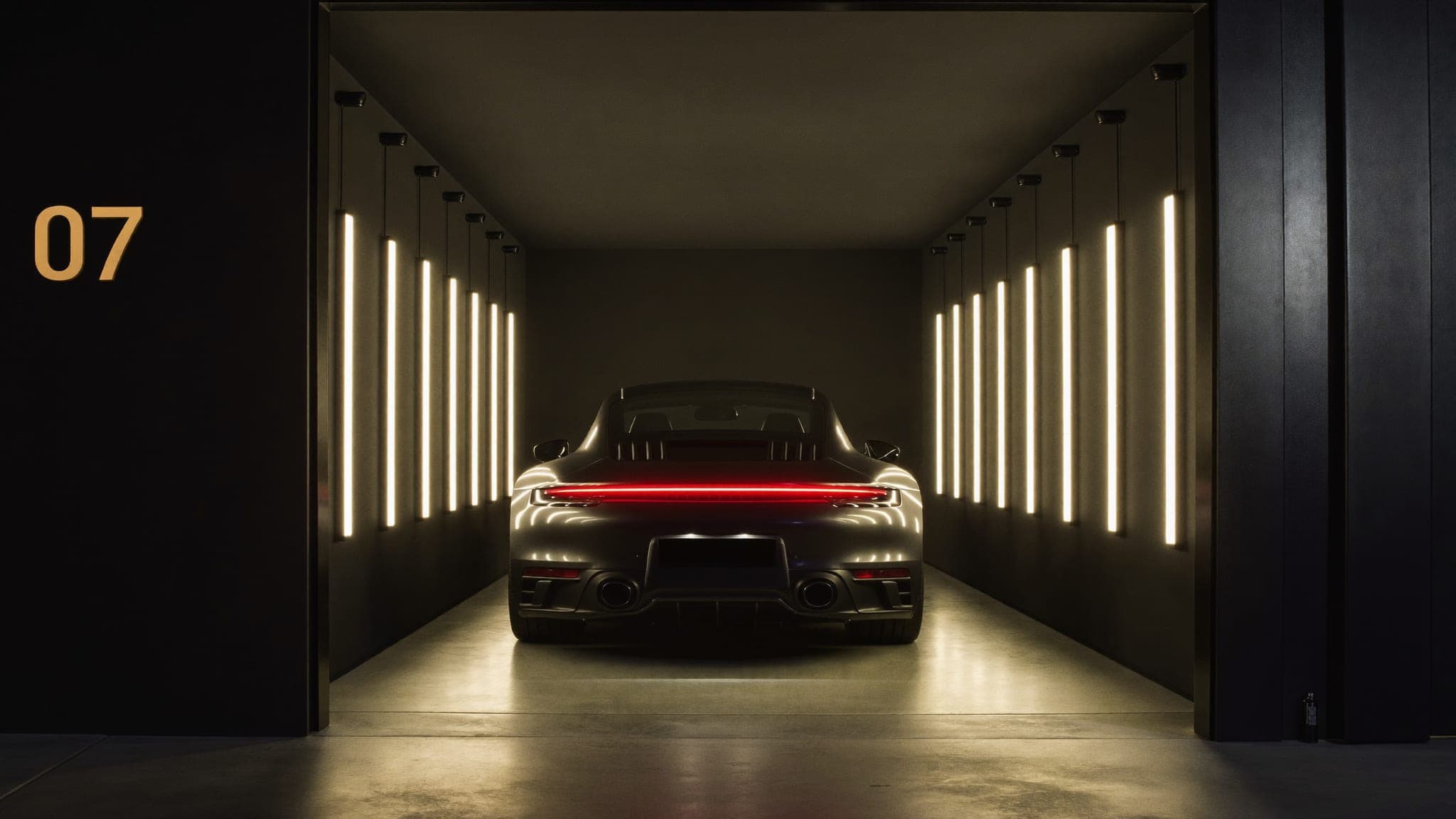 Single sports car stored in private bay 07 at Vault 620, framed by warm vertical light slots